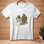 Bigfoot roasts a marshmallow by a campfire with a melting snowman and tent.
