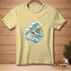 Light yellow t-shirt with snowman and turtle surfing a wave.