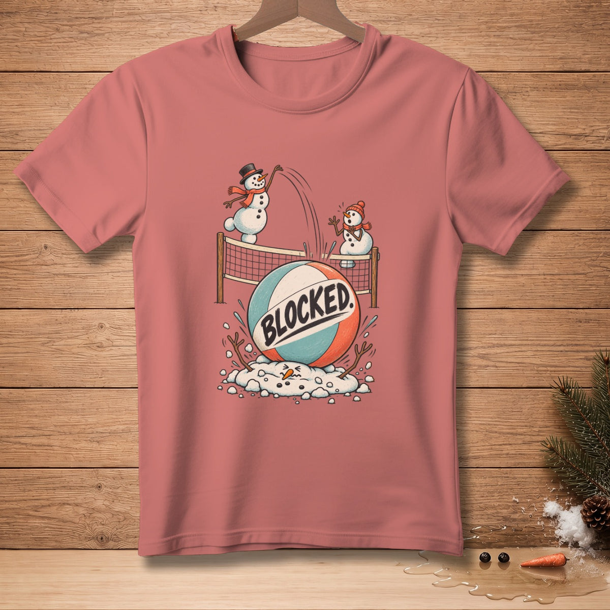 T-shirt graphic of snowmen playing volleyball with text "BLOCKED".