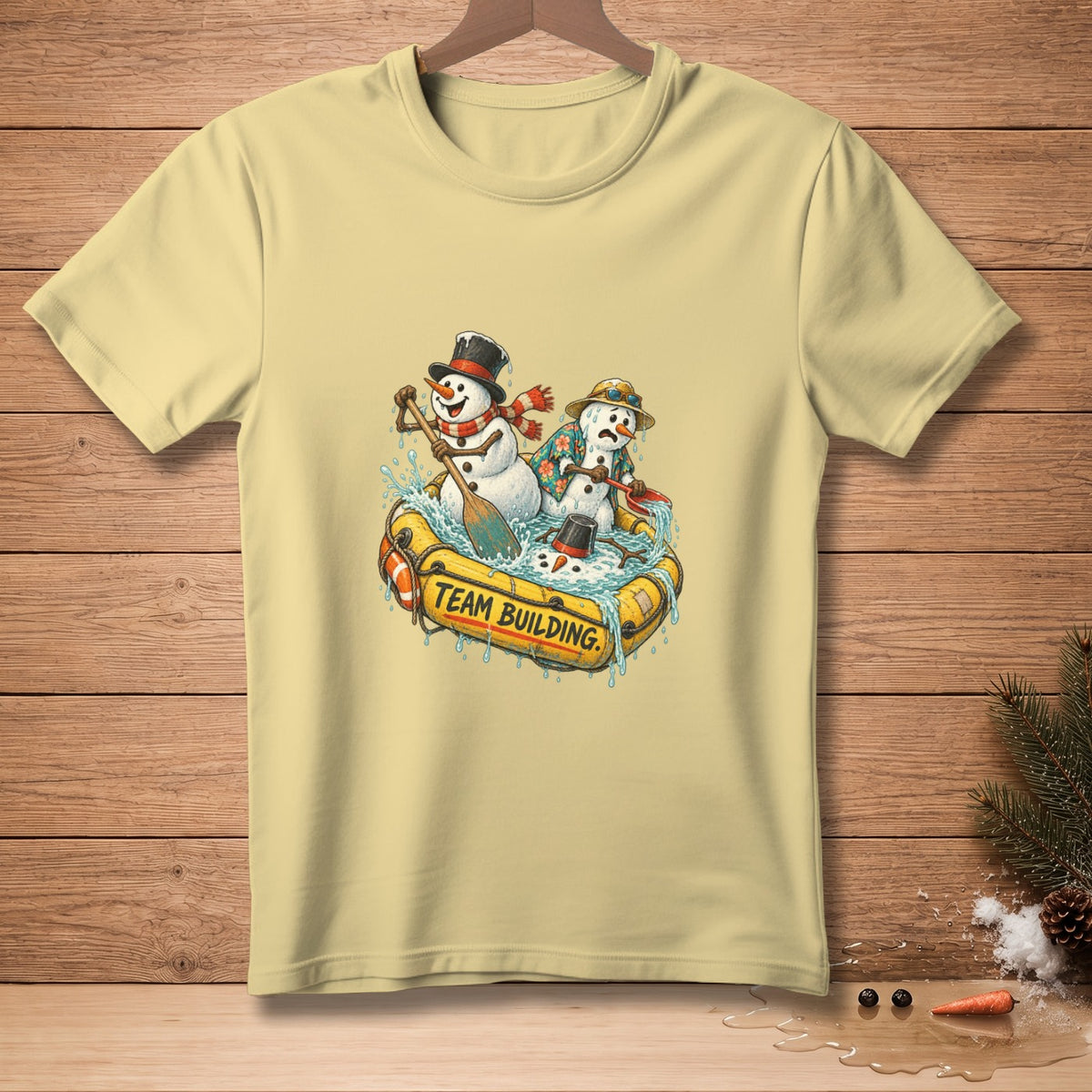 Snowmen in a raft with "Team Building" text, on a light yellow t-shirt.