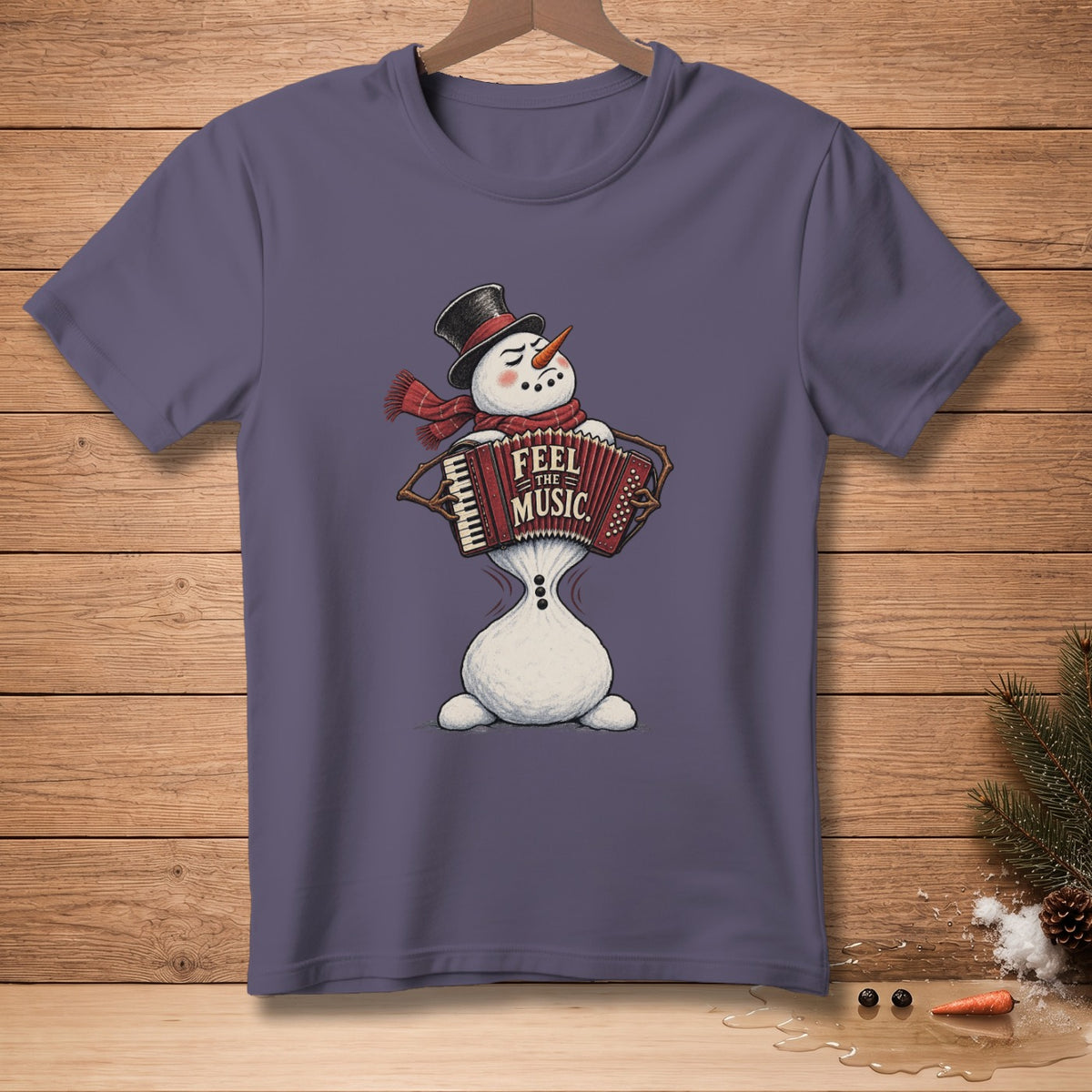 Purple t-shirt featuring a snowman playing an accordion with text "FEEL THE MUSIC".