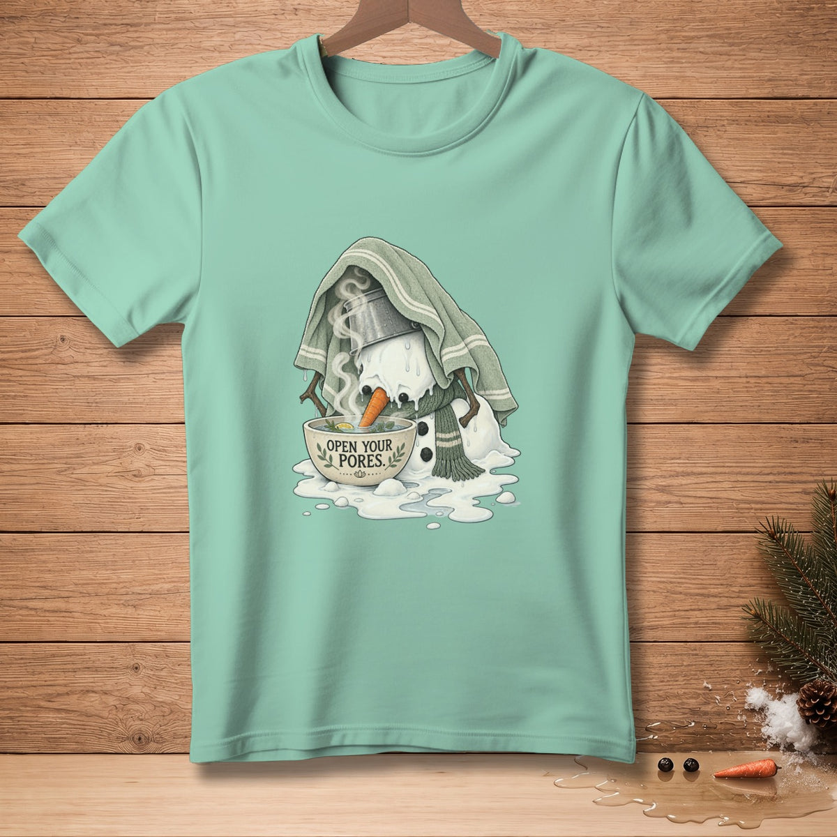 Melting snowman with steam and "Open Your Pores" text on a teal t-shirt.