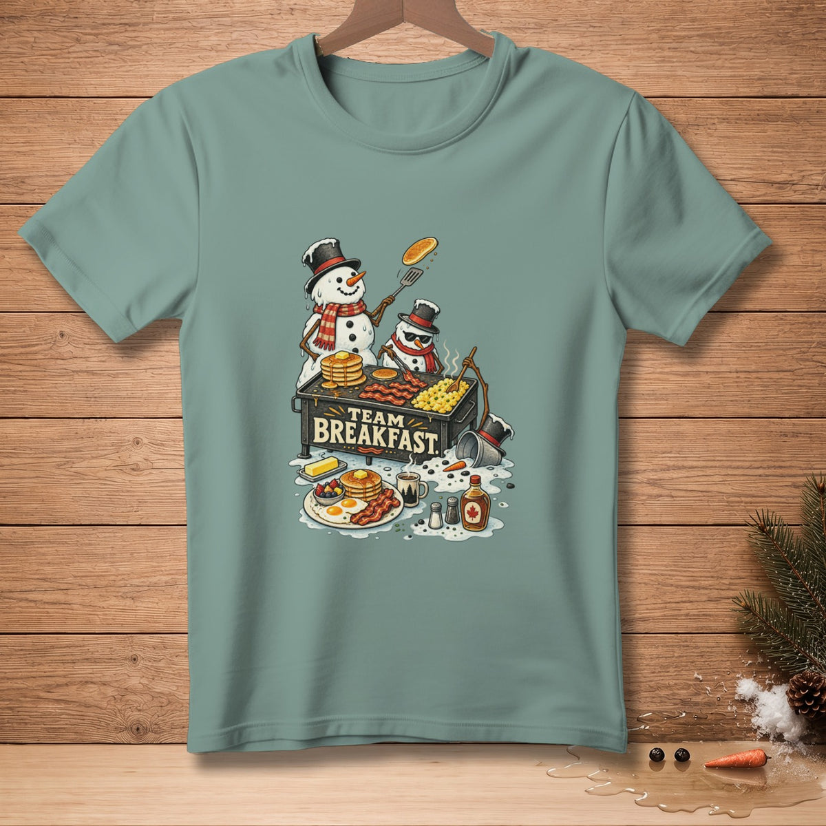 Two snowmen cook breakfast on a griddle with text "TEAM BREAKFAST".