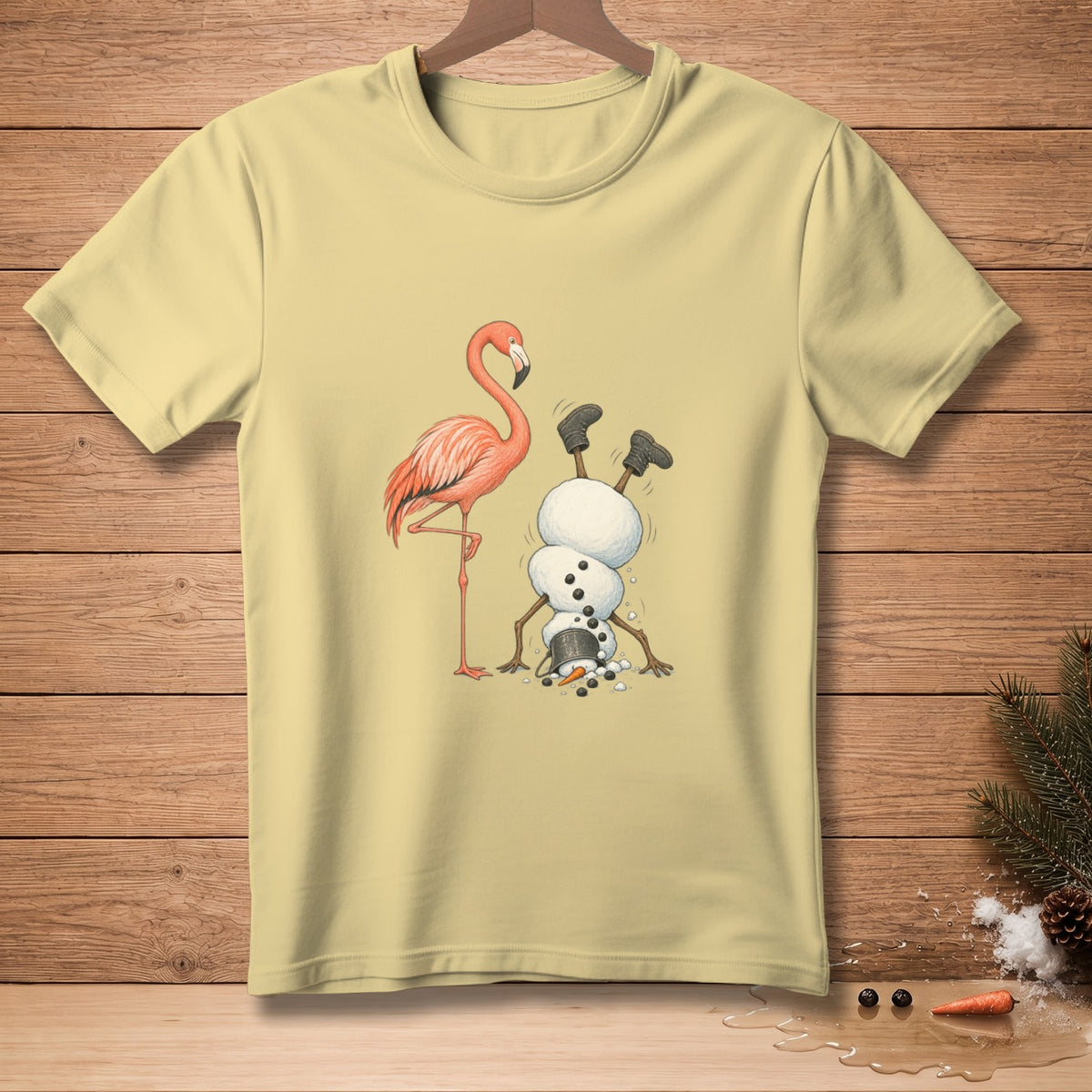 Light yellow t-shirt with a flamingo and a snowman doing a handstand graphic.