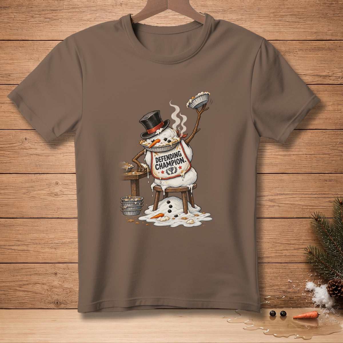 Snowman wearing a top hat and apron that says "Defending Champion," holding a pie.