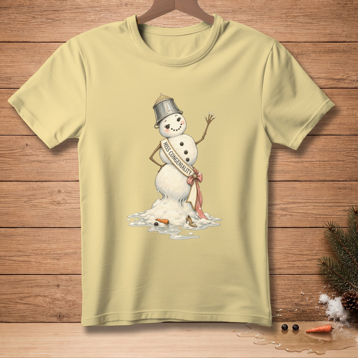 Yellow t-shirt with a melting snowman wearing a crown and "Miss Congeniality" sash.