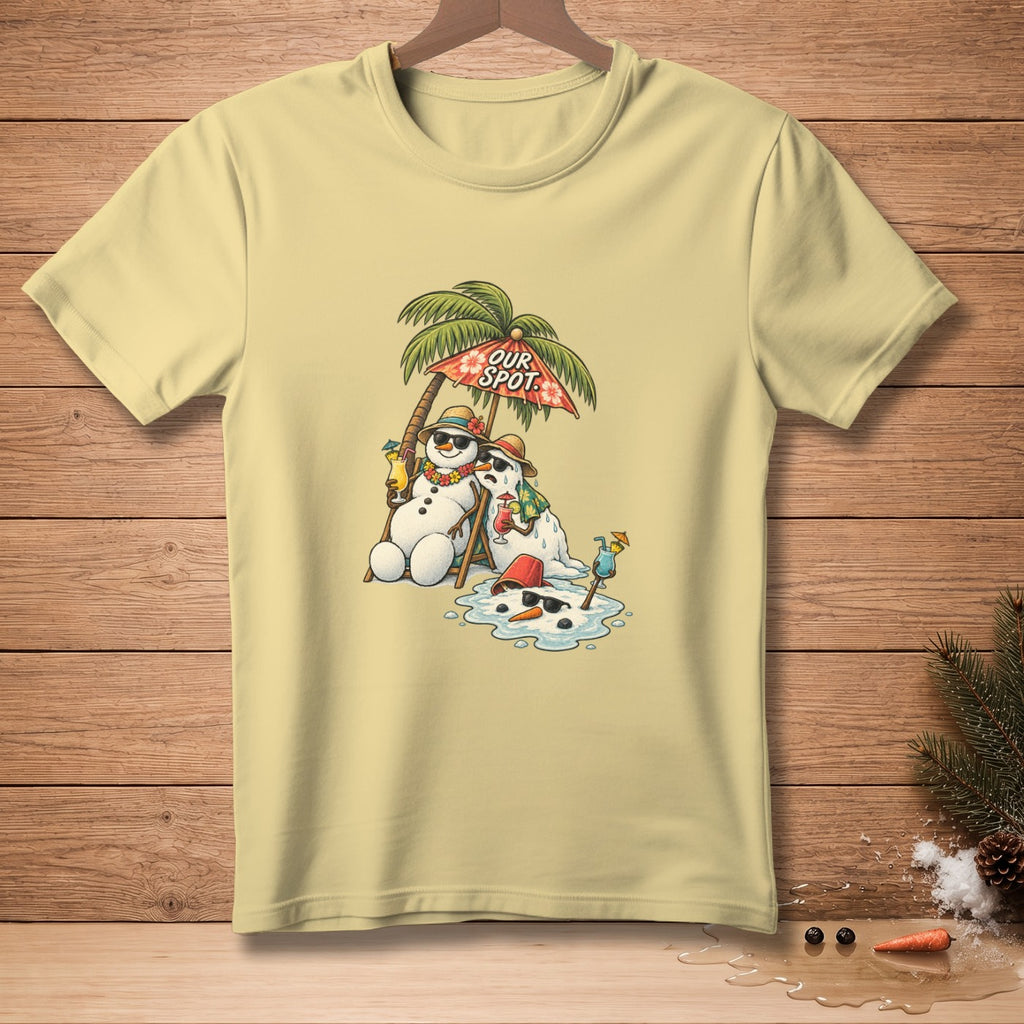 Light yellow t-shirt with graphic of melting snowmen on beach chairs under an umbrella.