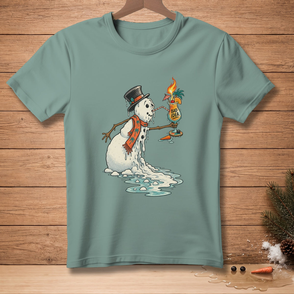Melting snowman with a drink labeled "Bad Idea" on a teal shirt.