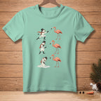 Snowmen fence and golf with flamingos on a light teal t-shirt.