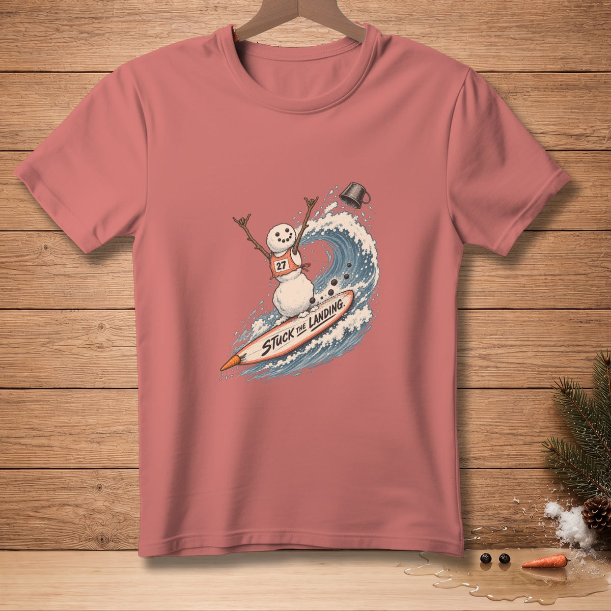 Snowman on surfboard riding a wave with "STUCK THE LANDING" text.