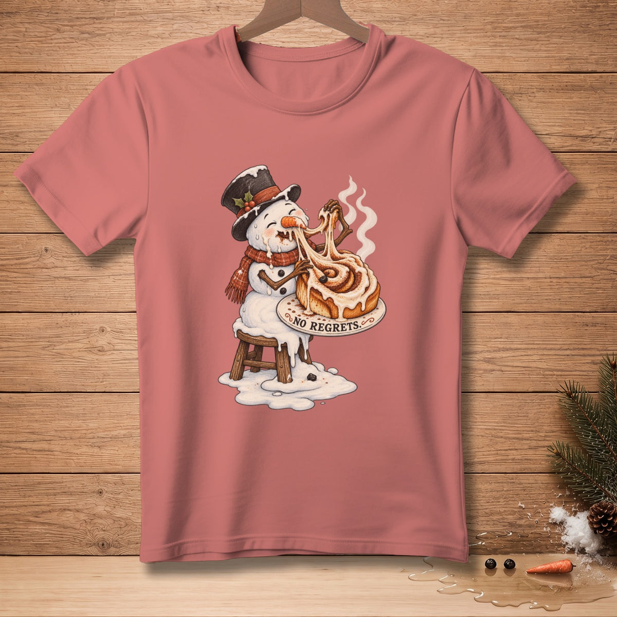 Snowman melting while eating a giant cinnamon roll with "NO REGRETS" text.