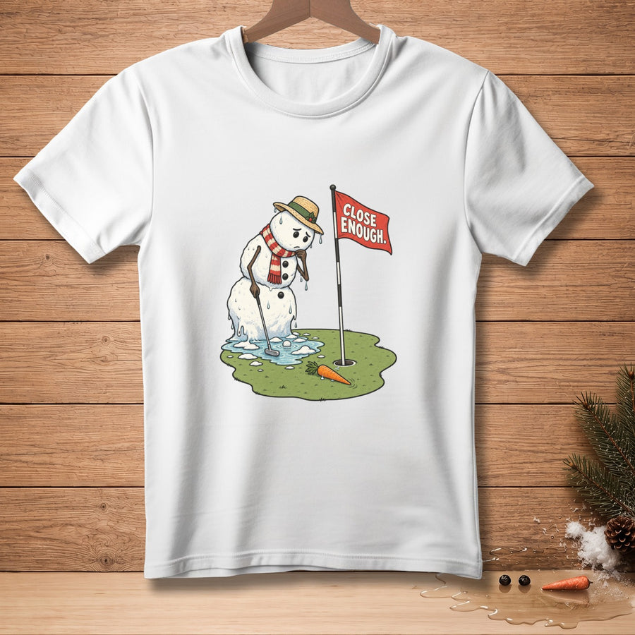 Melting snowman on golf course with "Close Enough" flag and carrot.