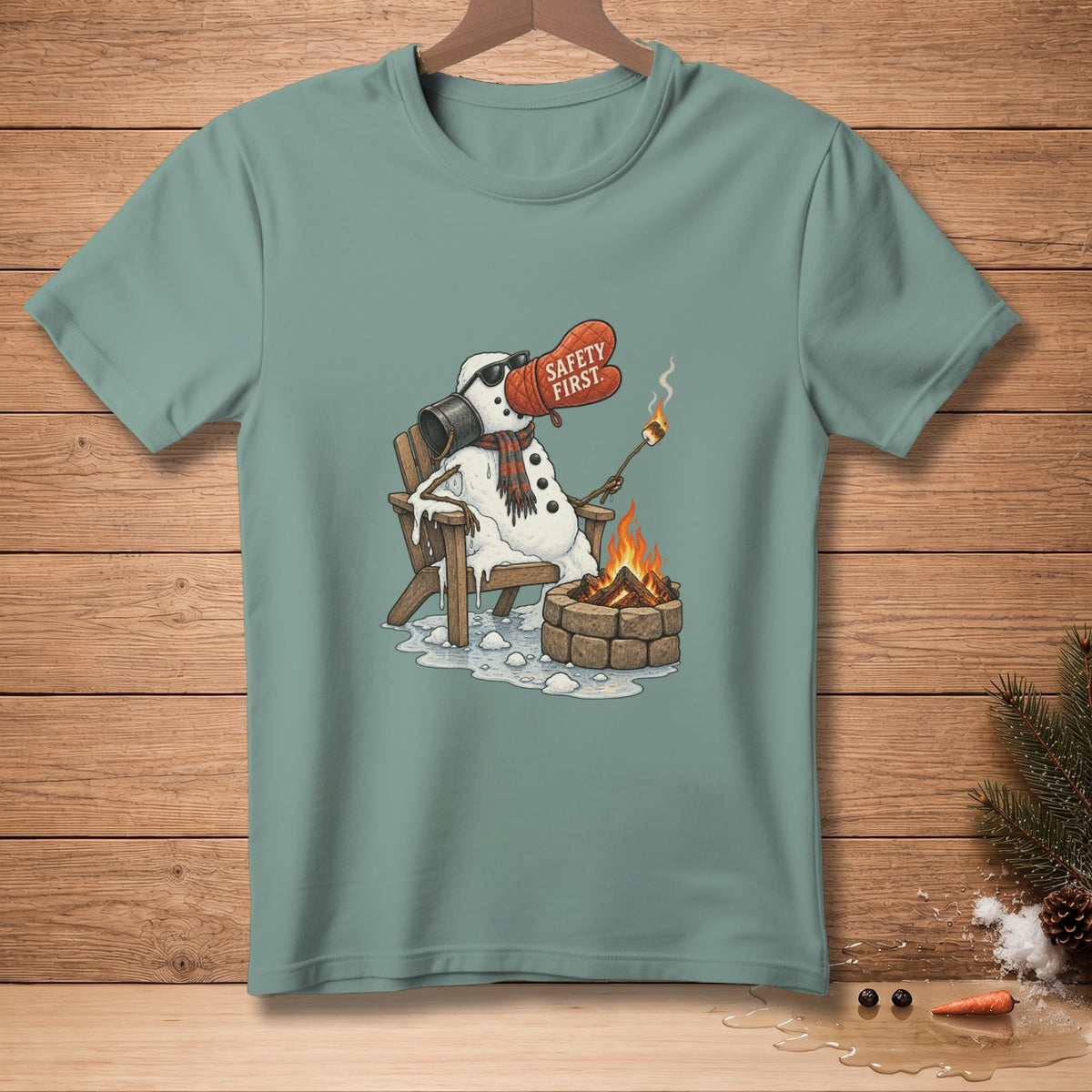 Snowman wearing sunglasses and oven mitt with "Safety First" roasting marshmallow by a campfire.