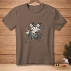 Brown t-shirt featuring snowmen riding a tandem bicycle with text "WE FIT."