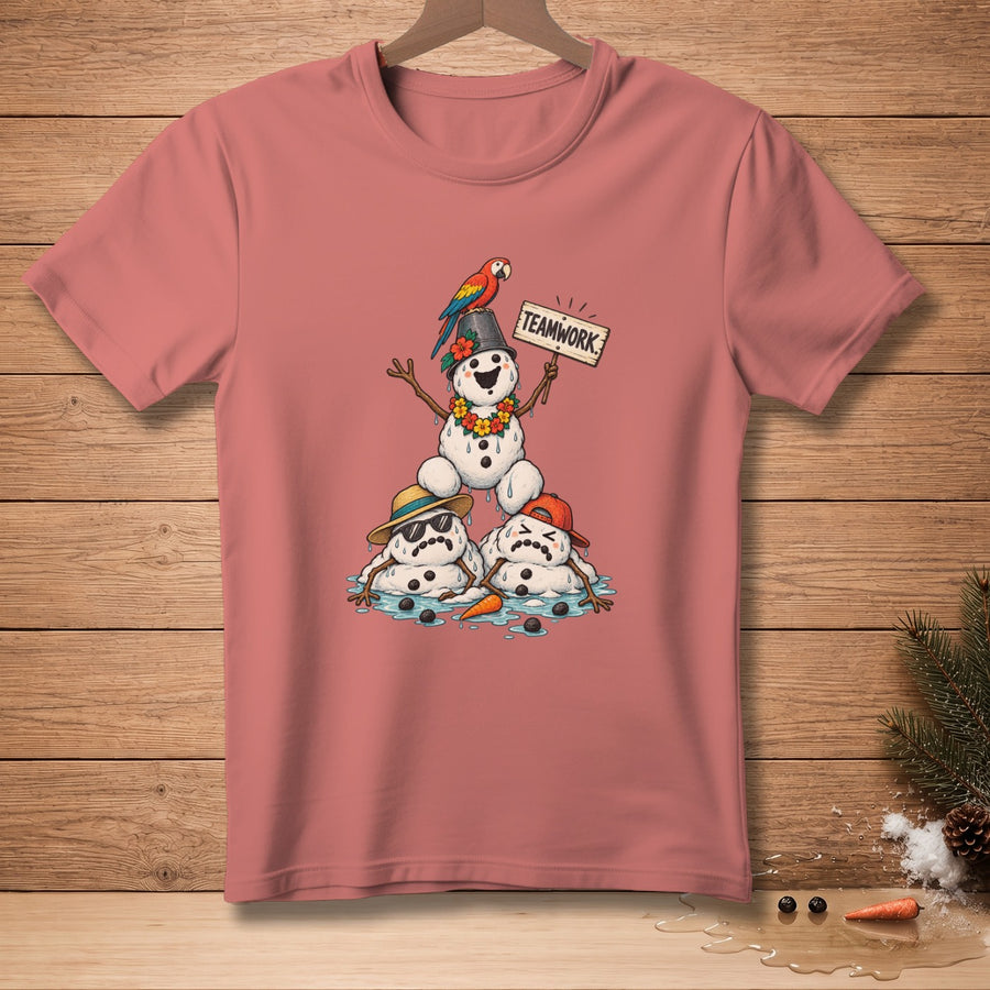 Illustration of melting snowmen with a parrot and "TEAMWORK" sign on a pink t-shirt.