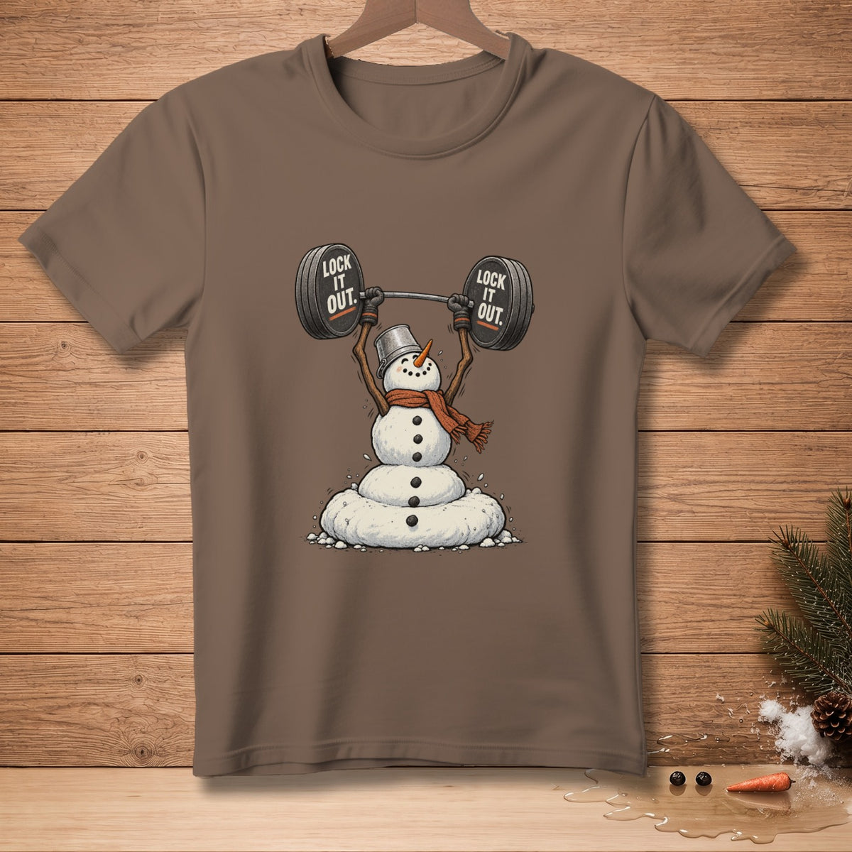 Brown t-shirt with snowman lifting a barbell, text "LOCK IT OUT."