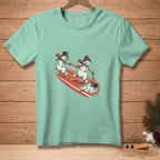 Two snowmen on a surfboard, one holding a "Don't Drop It" banner.