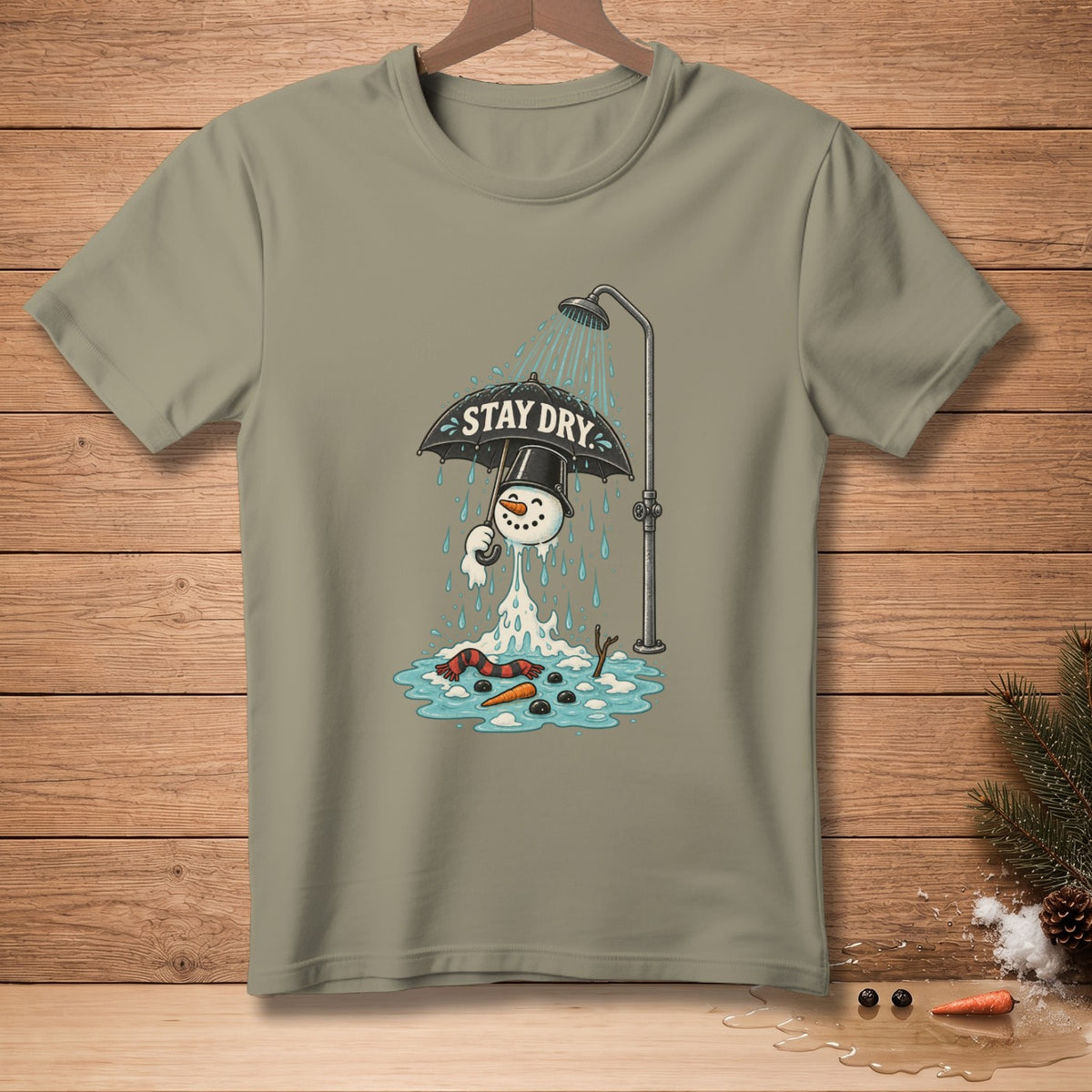 Snowman under shower holding umbrella with "STAY DRY" text, melting on a shirt.