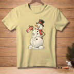Light yellow t-shirt with a melting snowman spraying whipped cream from a can labeled "SEAMLESS."