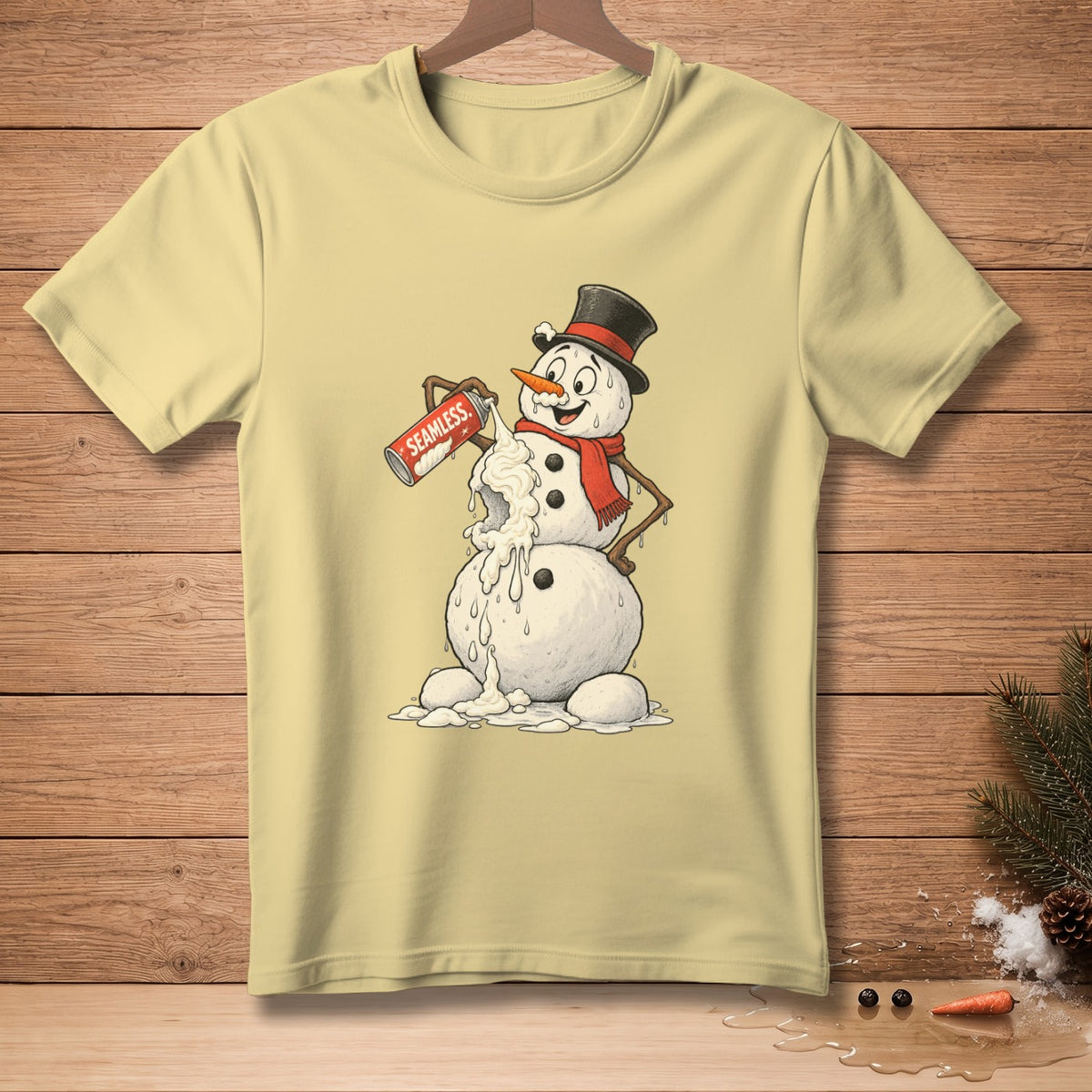 Light yellow t-shirt with a melting snowman spraying whipped cream from a can labeled "SEAMLESS."