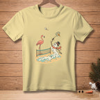 Light yellow t-shirt with a cartoon of a melting snowman playing badminton with a flamingo.