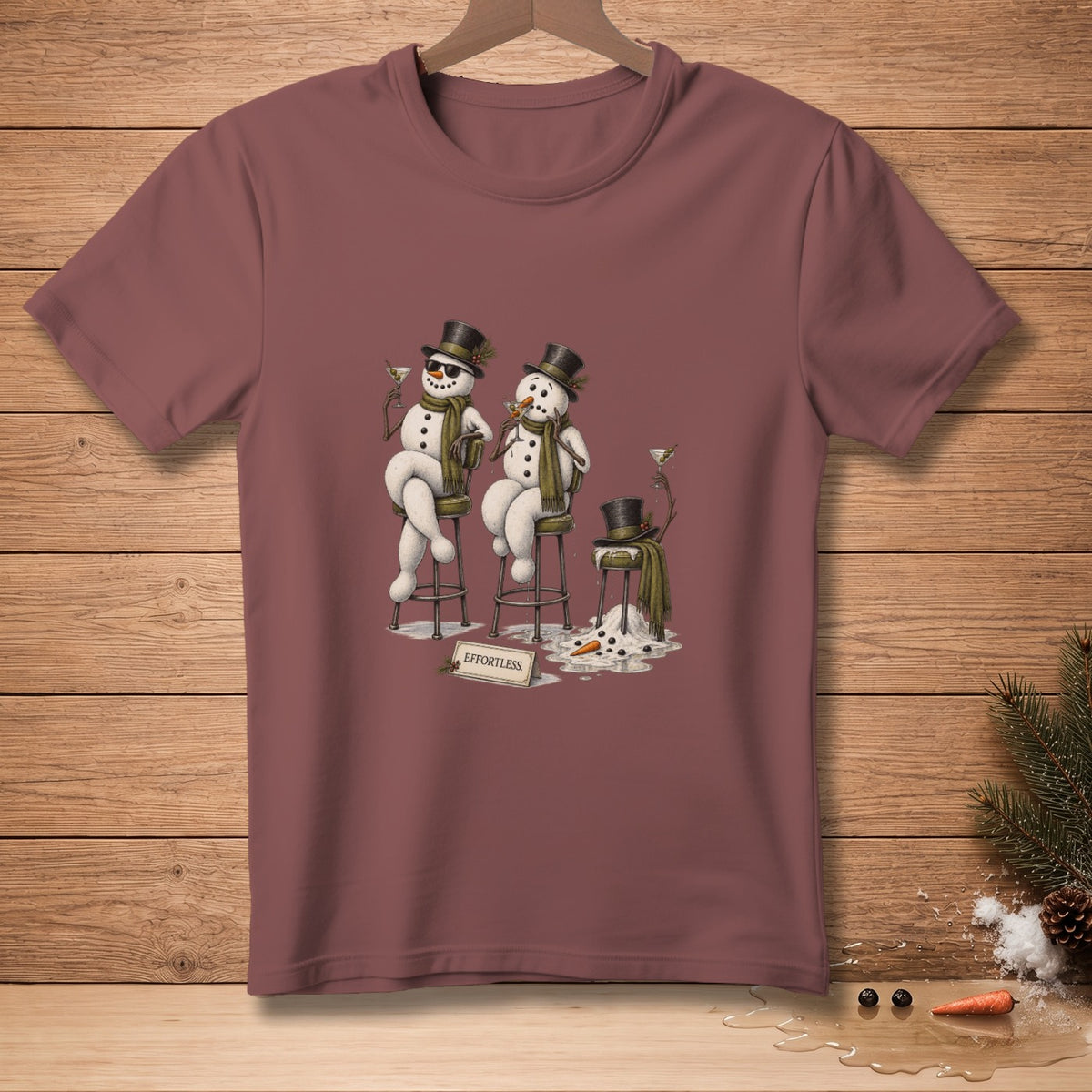 Three snowmen wearing hats and scarves with martinis, one melting, with "EFFORTLESS" sign.