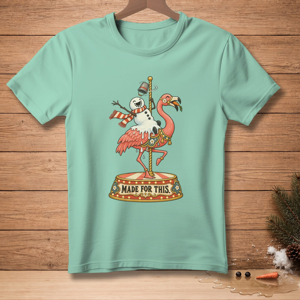 Mint green t-shirt with a cartoon flamingo and snowman on a carousel, saying "Made For This".