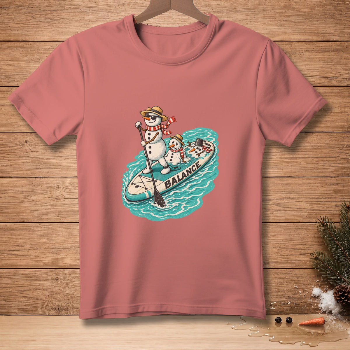 Snowmen with hats and scarves paddleboarding on a surfboard with the word "BALANCE".