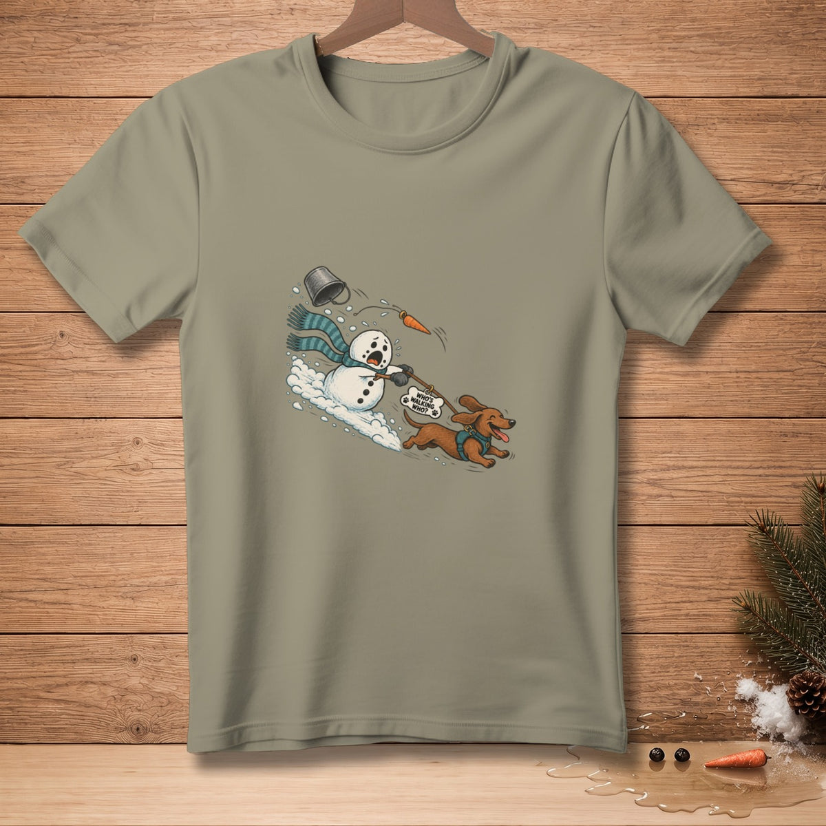 T-shirt graphic of a snowman and dachshund on a leash, with text "WHO'S WALKING WHO?".