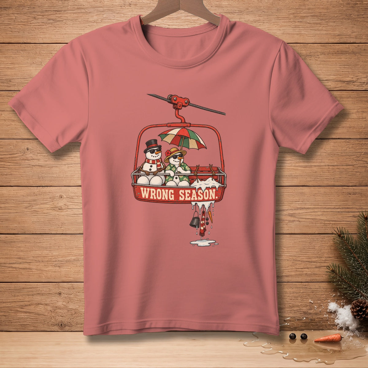 Two snowmen ride a ski lift with an umbrella under the words "WRONG SEASON".