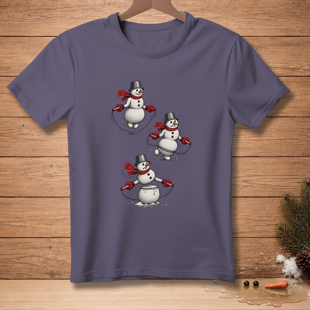 T-shirt with cartoon snowmen wearing bucket hats and red scarves jumping rope.