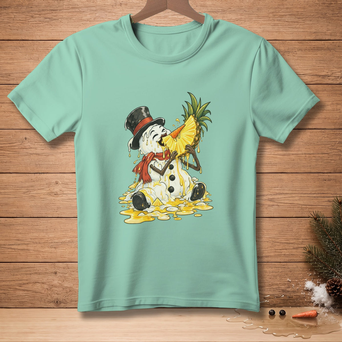 Melting snowman in top hat eating pineapple slice on light blue t-shirt.