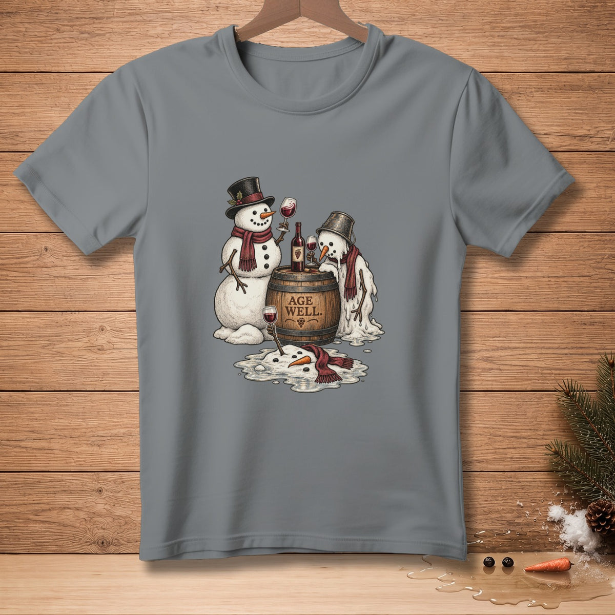 Two snowmen and a melting snowman with wine on a barrel that says "AGE WELL".