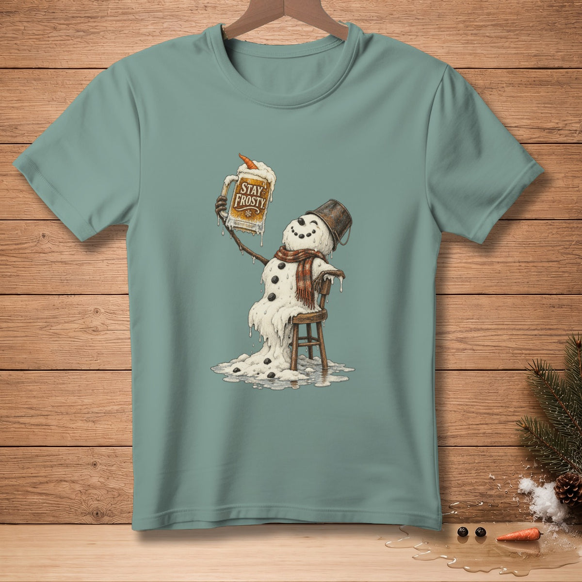 Melting snowman in a bucket hat and scarf holds mug that says "Stay Frosty".