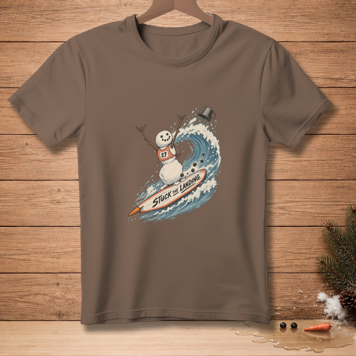 Snowman surfing a wave on a surfboard with text "STUCK THE LANDING."