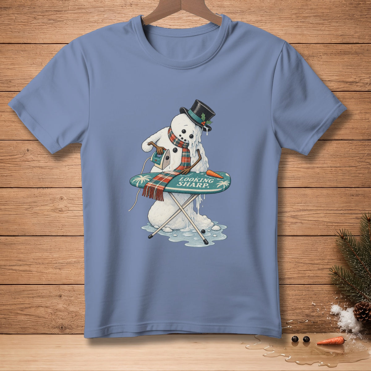 Snowman ironing on an ironing board with "LOOKING SHARP." text.