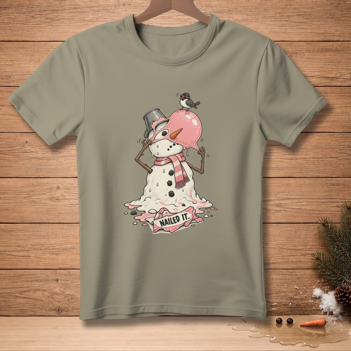 T-shirt with melting snowman graphic and "NAILED IT." text banner.