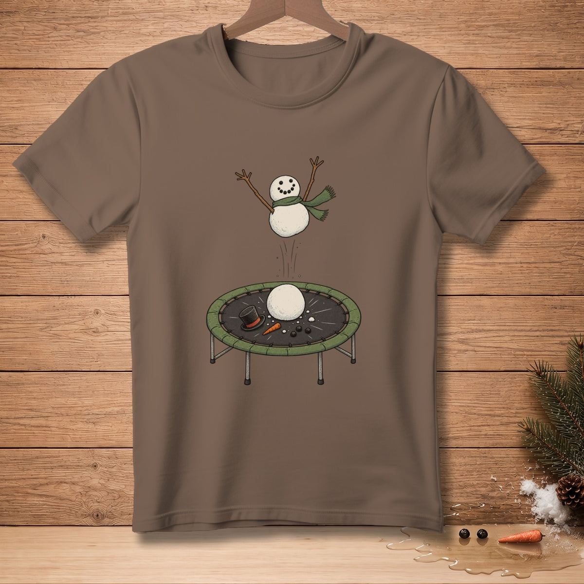 Snowman jumping on trampoline with parts on the ground, on a brown t-shirt.
