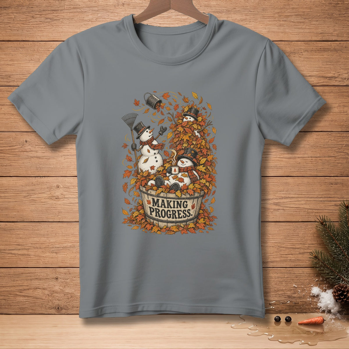 Snowmen in autumn leaves with "Making Progress" text on a gray t-shirt.