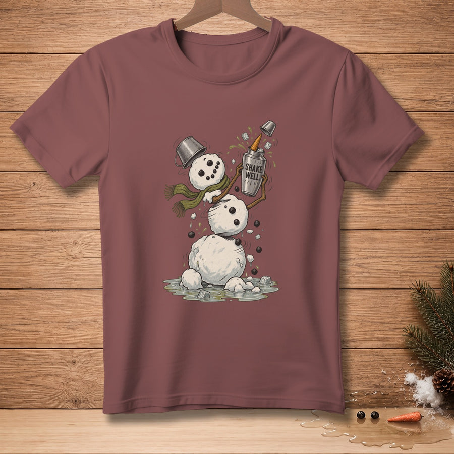 Snowman shaking cocktail shaker with "Shake Well" text on maroon t-shirt.