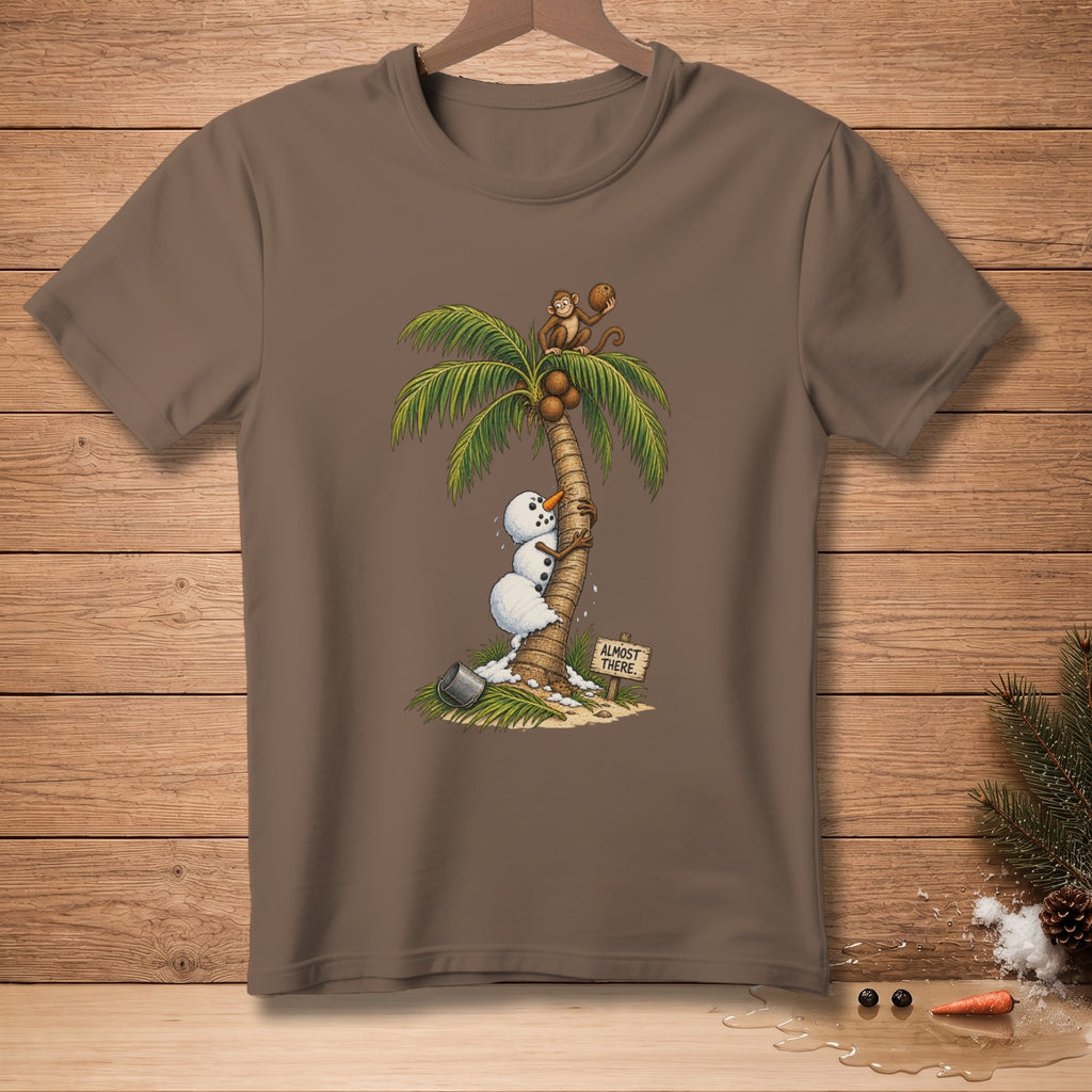 Snowman climbing palm tree with monkey, sign says "Almost There".