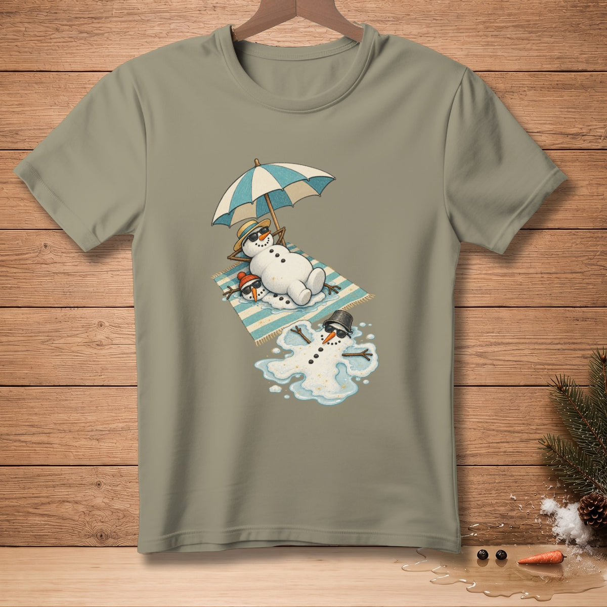 T-shirt with cartoon snowmen melting under an umbrella on a beach towel.