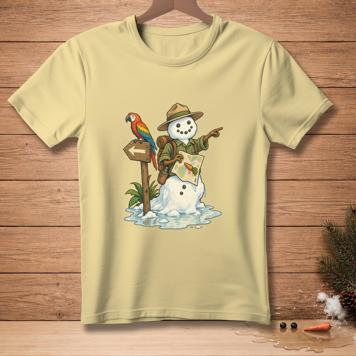 Snowman adventurer with parrot and map pointing direction on light yellow t-shirt.