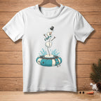White t-shirt with graphic of a snowman jumping into a blue and white inflatable ring.