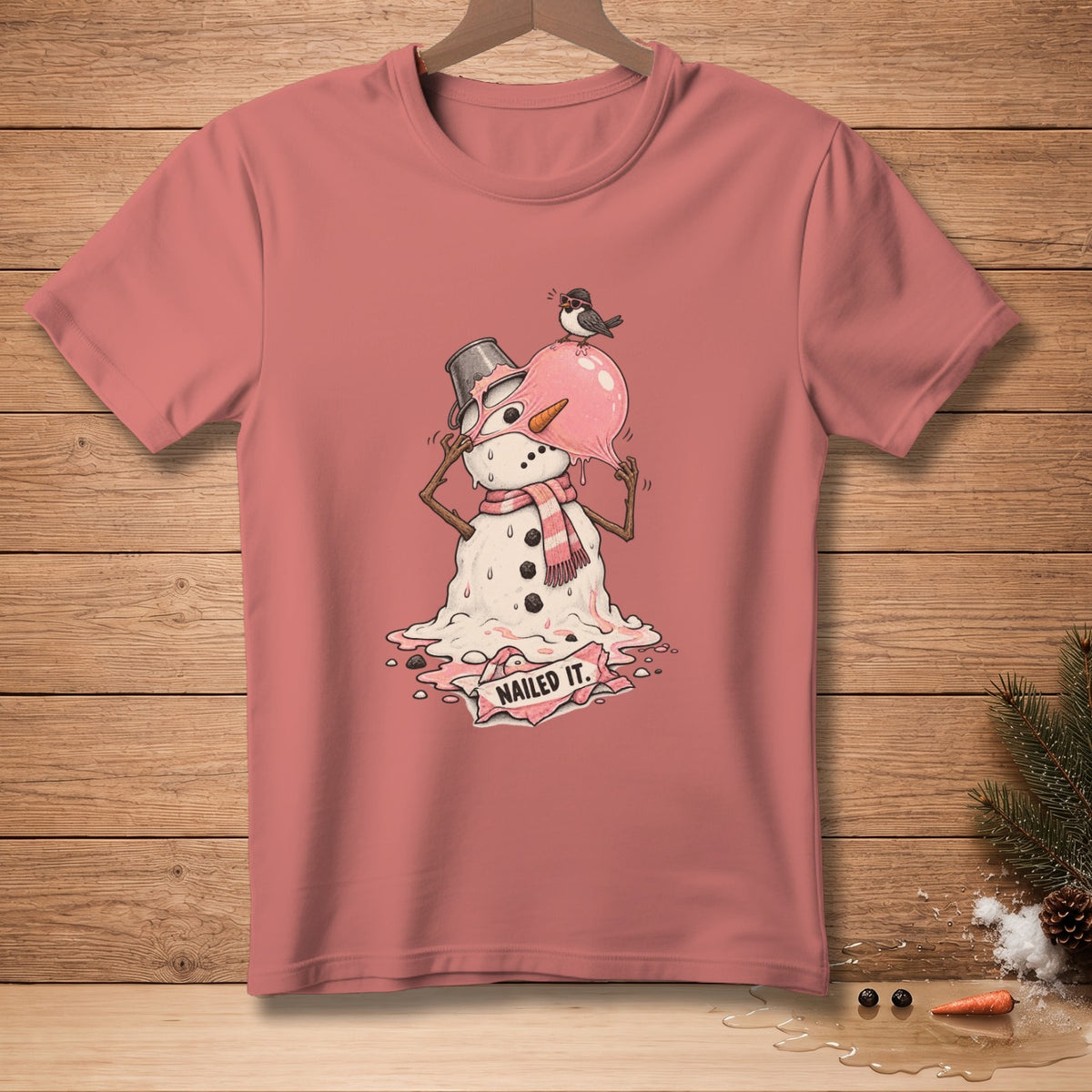 T-shirt with melting snowman graphic, bird on hat, and "NAILED IT." text.