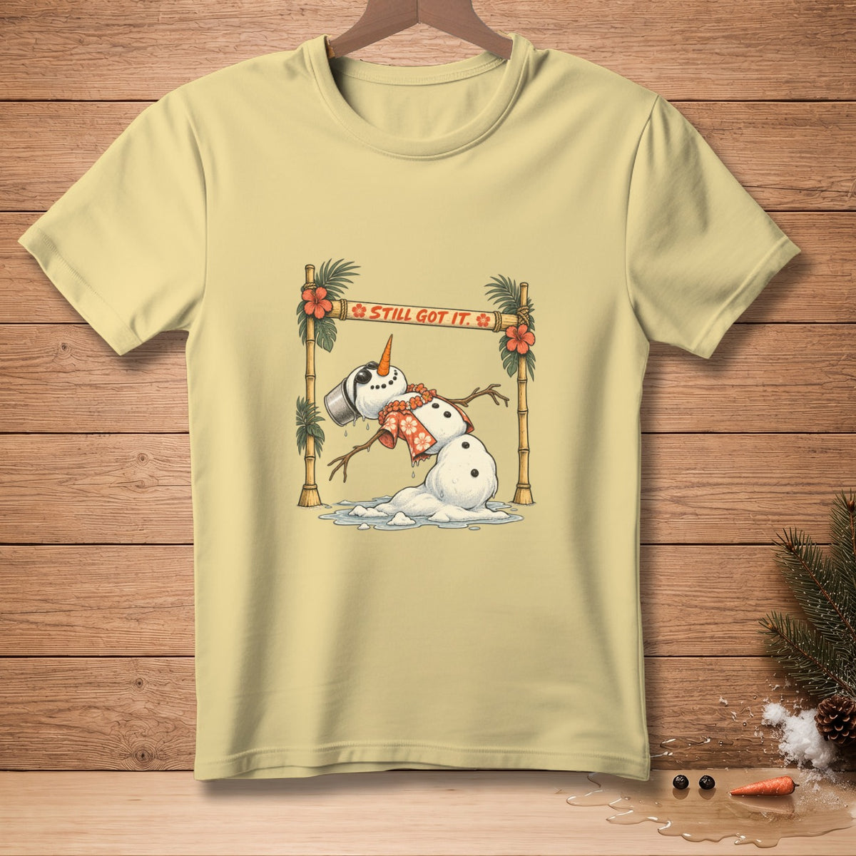 Yellow t-shirt with melting snowman, Hawaiian leis, and text "STILL GOT IT."
