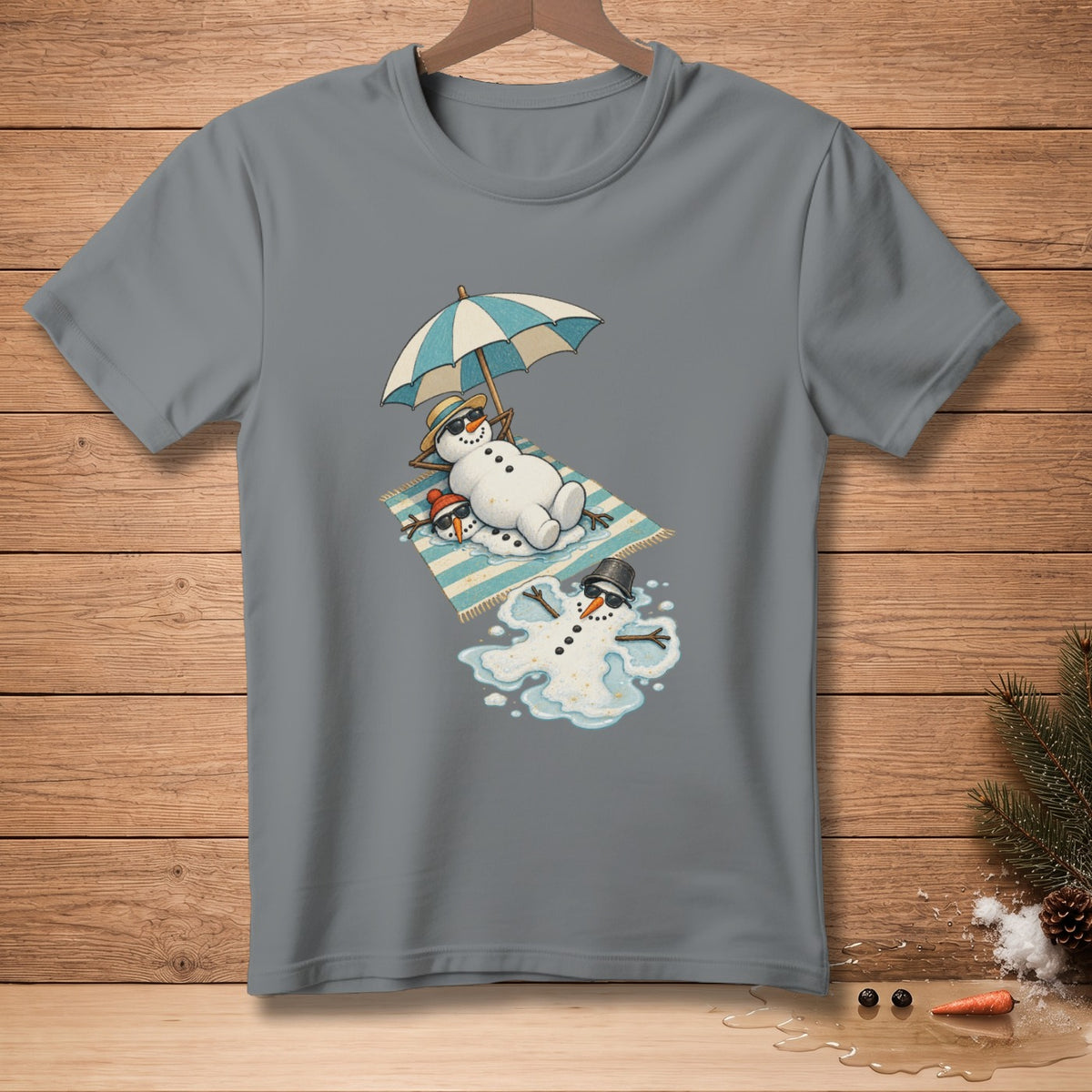 T-shirt graphic featuring melting snowmen lounging under an umbrella on a beach towel.