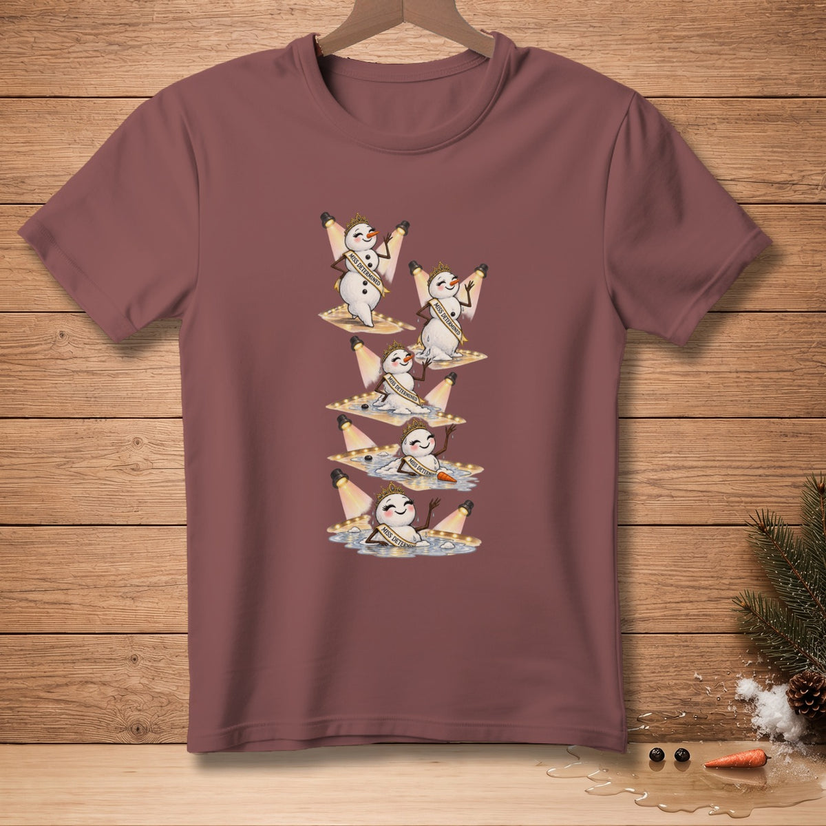 Snowmen with "Miss Determined" sashes and crowns melt under spotlights.