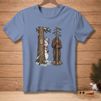 Snowman peeking from behind a tree, Bigfoot holding a tree. Text: Nailed it.