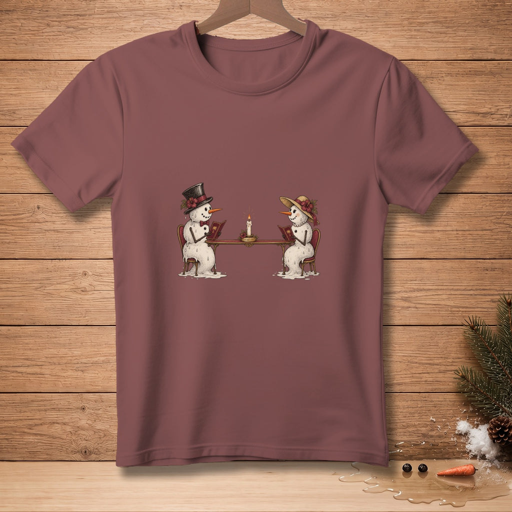 Two snowmen in hats sit at a table reading books next to a candle.
